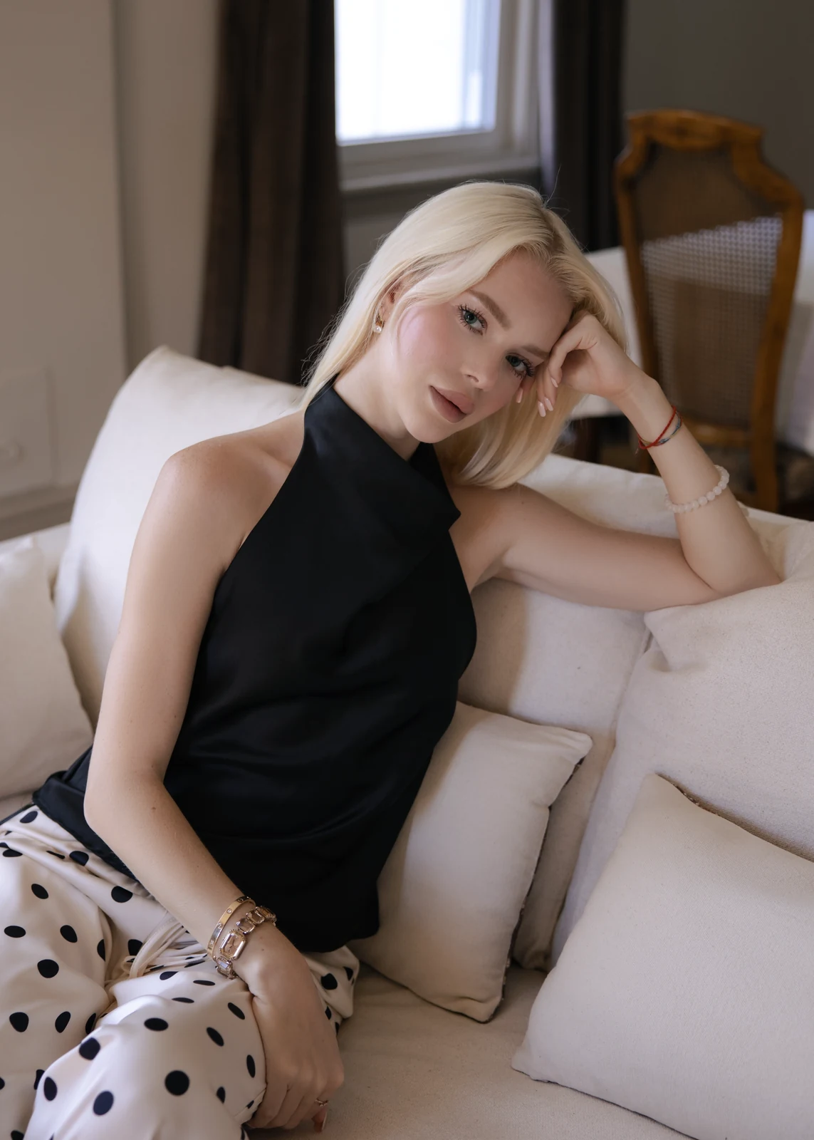 Lifestyle portrait from an indoor session — candid pose in a home setting.