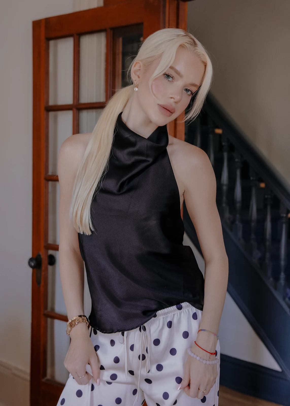 Lifestyle portrait from an indoor session — candid pose in a home setting.