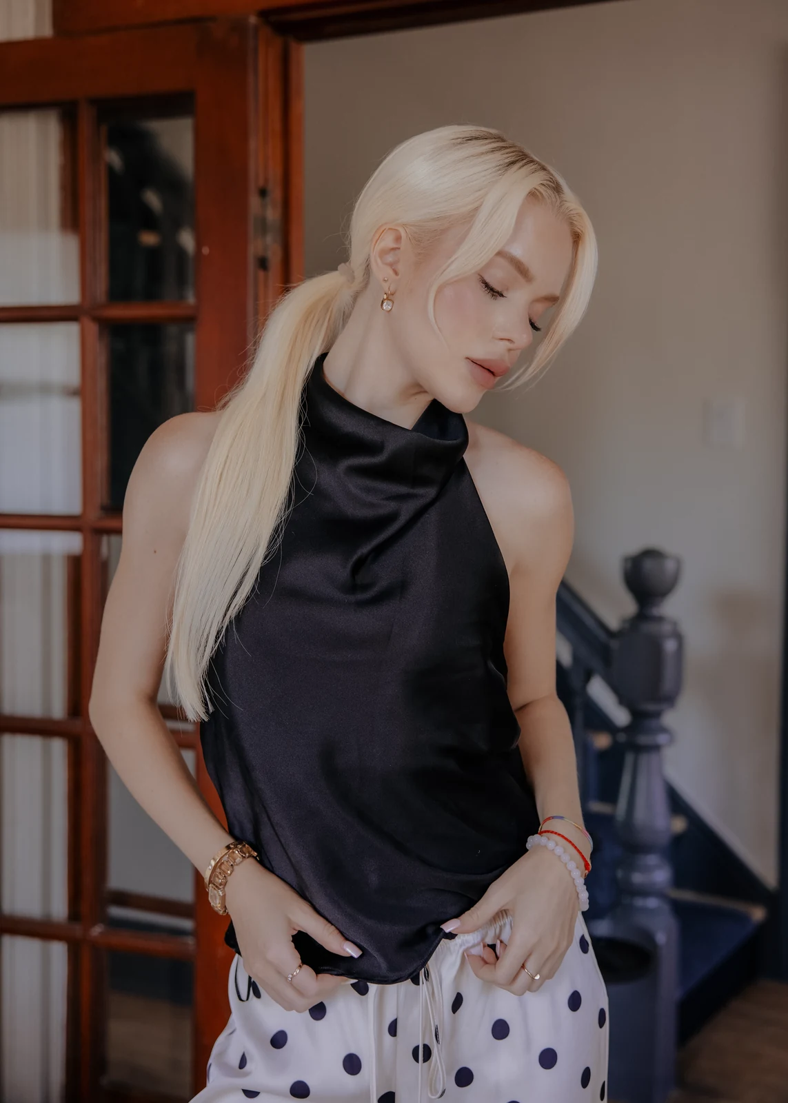 Lifestyle portrait from an indoor session — candid pose in a home setting.