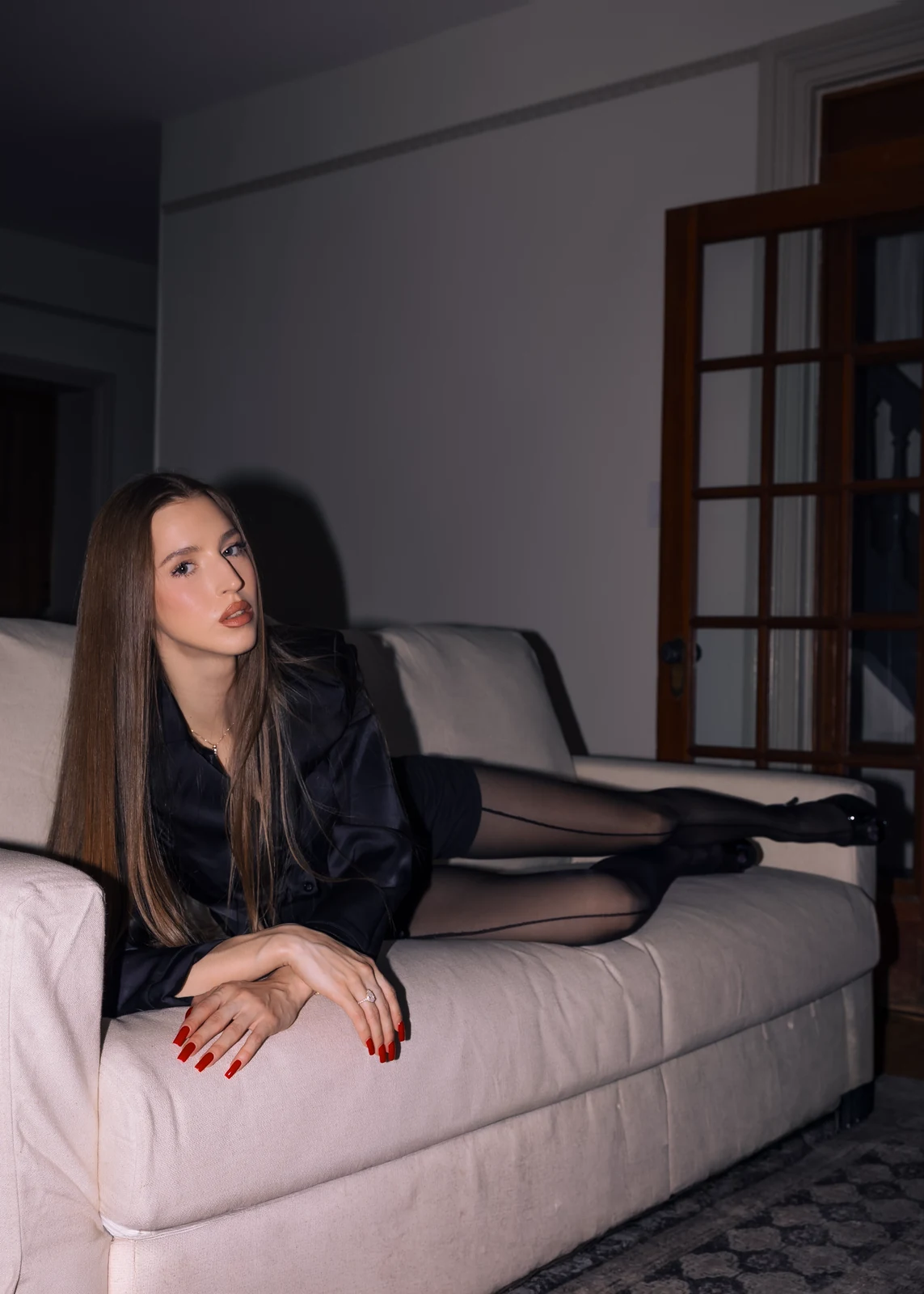 Lifestyle portrait from an indoor session — candid pose in a home setting.
