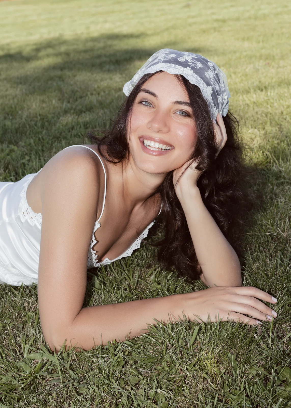 Outdoor portrait from a natural-light session — grass, trees, and golden-hour light.