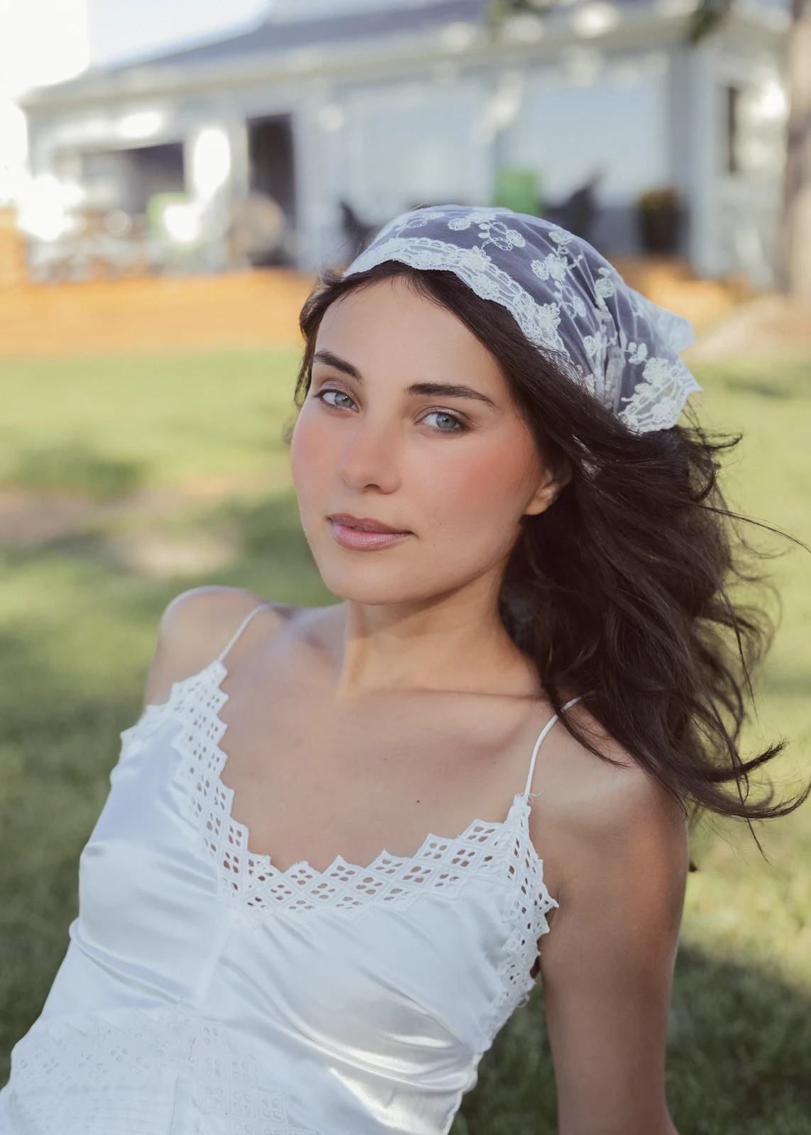 Outdoor portrait from a natural-light session — grass, trees, and golden-hour light.