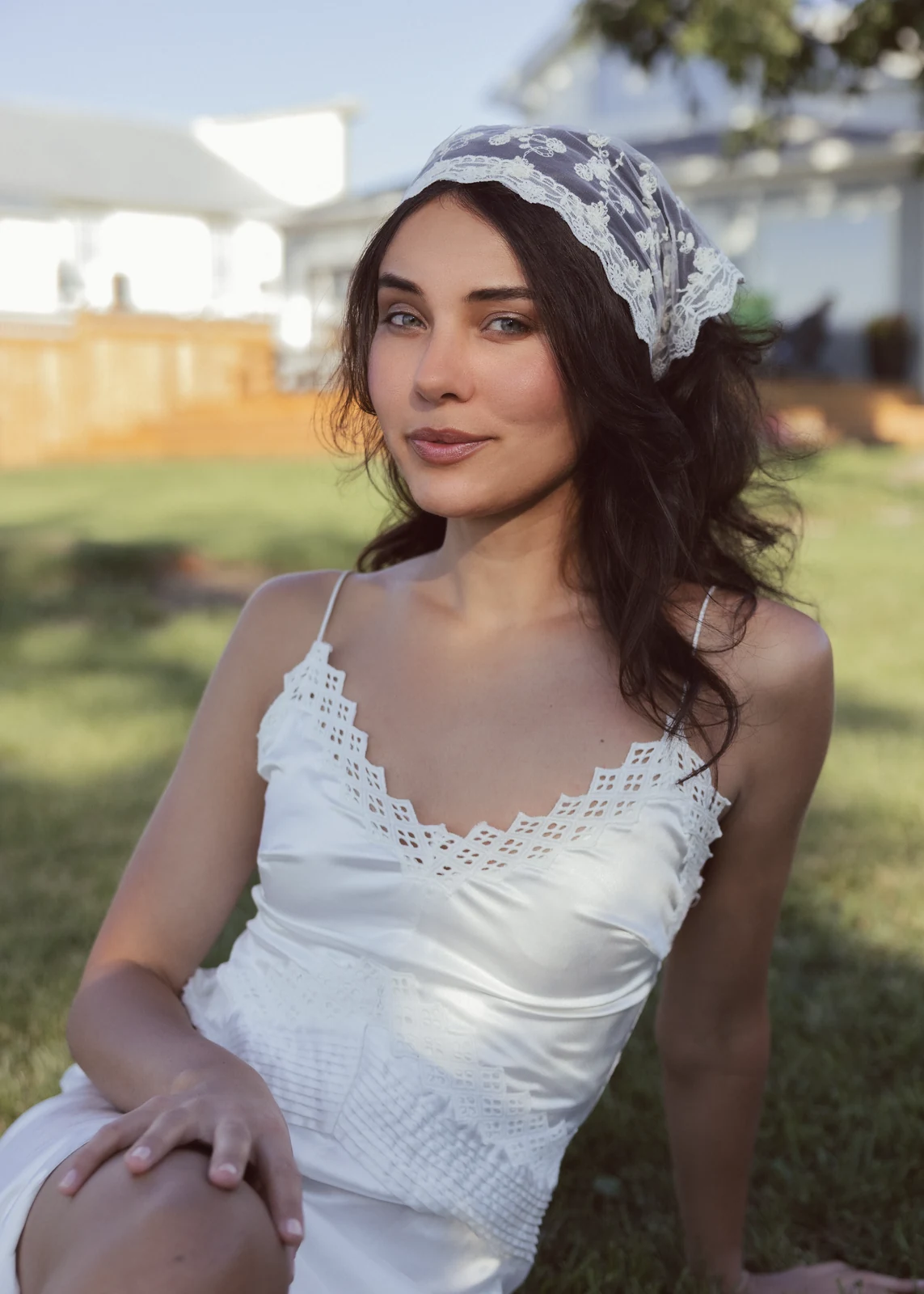 Outdoor portrait from a natural-light session — grass, trees, and golden-hour light.
