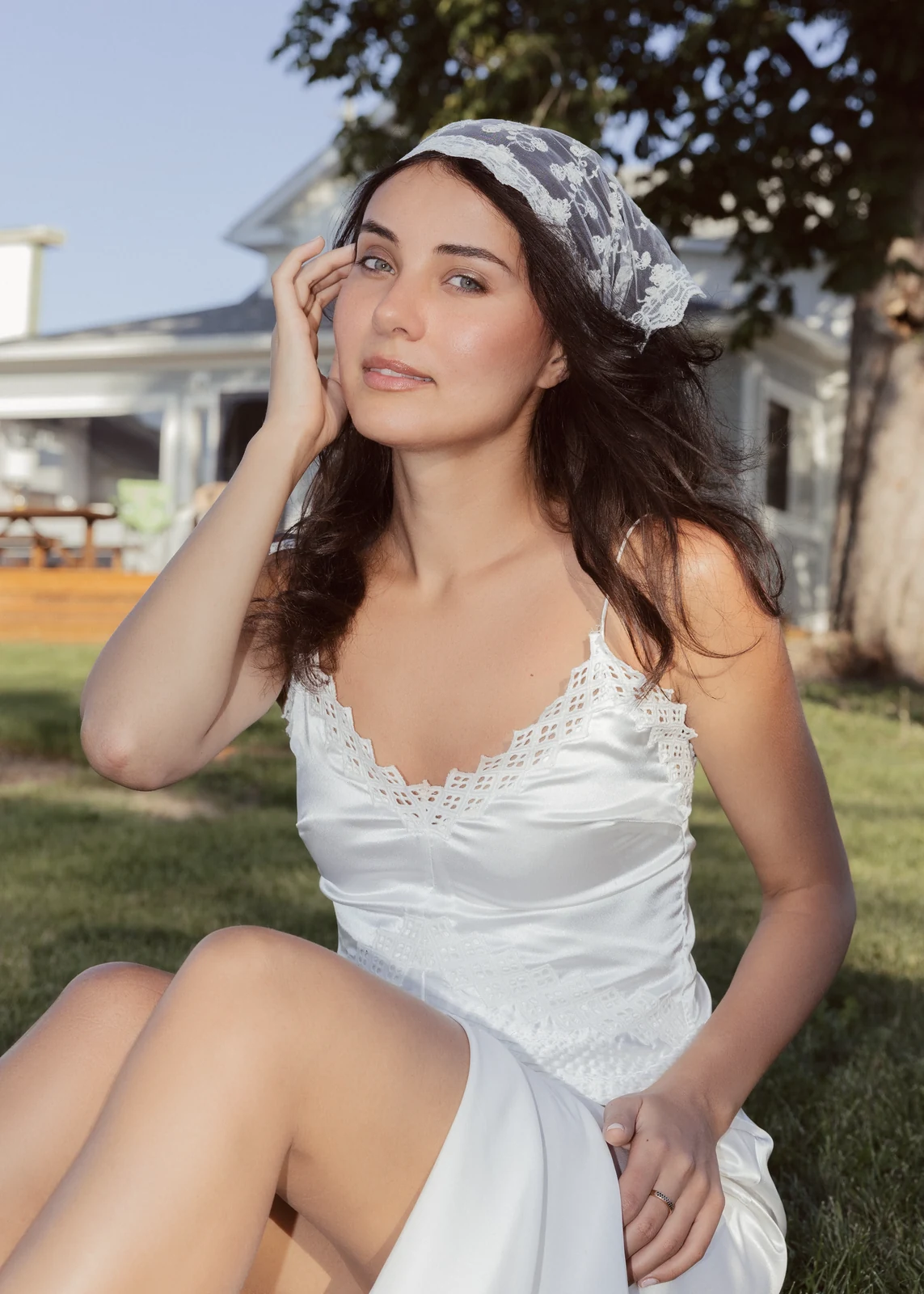 Outdoor portrait from a natural-light session — grass, trees, and golden-hour light.