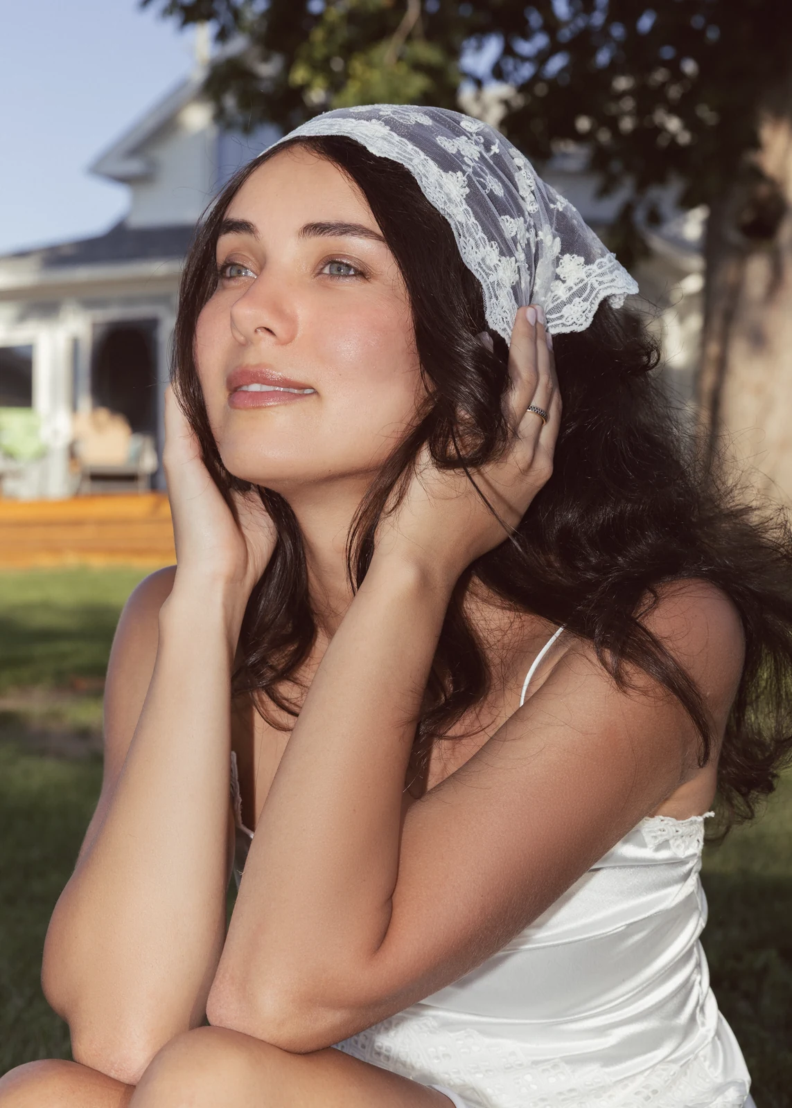Outdoor portrait from a natural-light session — grass, trees, and golden-hour light.