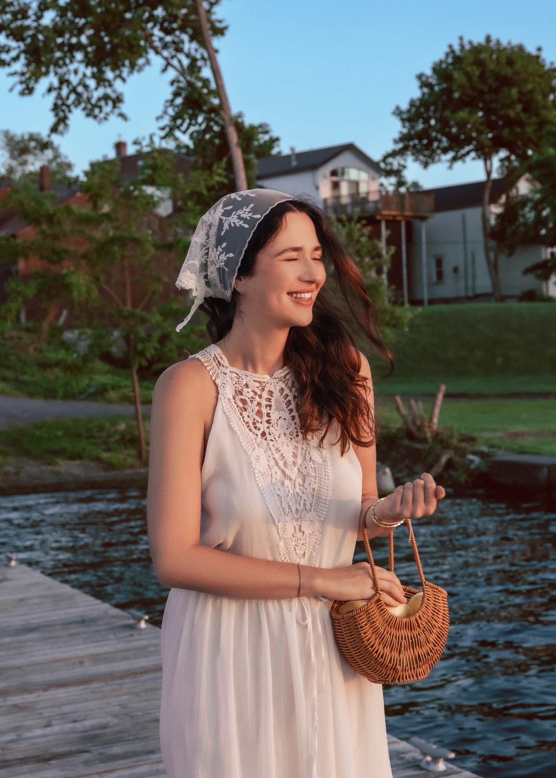 Outdoor portrait from a natural-light session — grass, trees, and golden-hour light.
