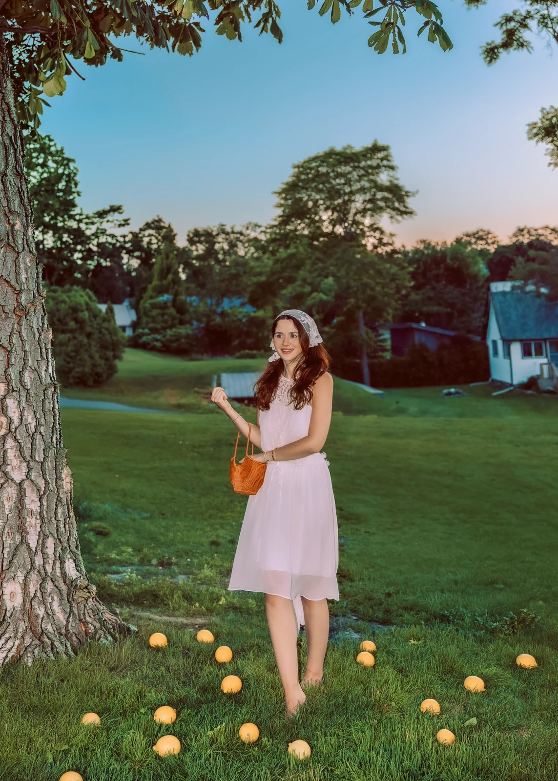 Outdoor portrait from a natural-light session — grass, trees, and golden-hour light.