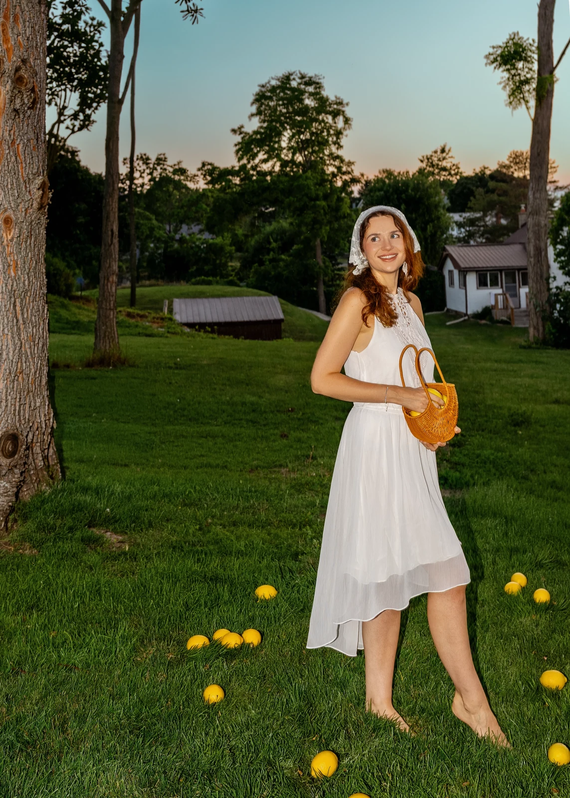 Outdoor portrait from a natural-light session — grass, trees, and golden-hour light.
