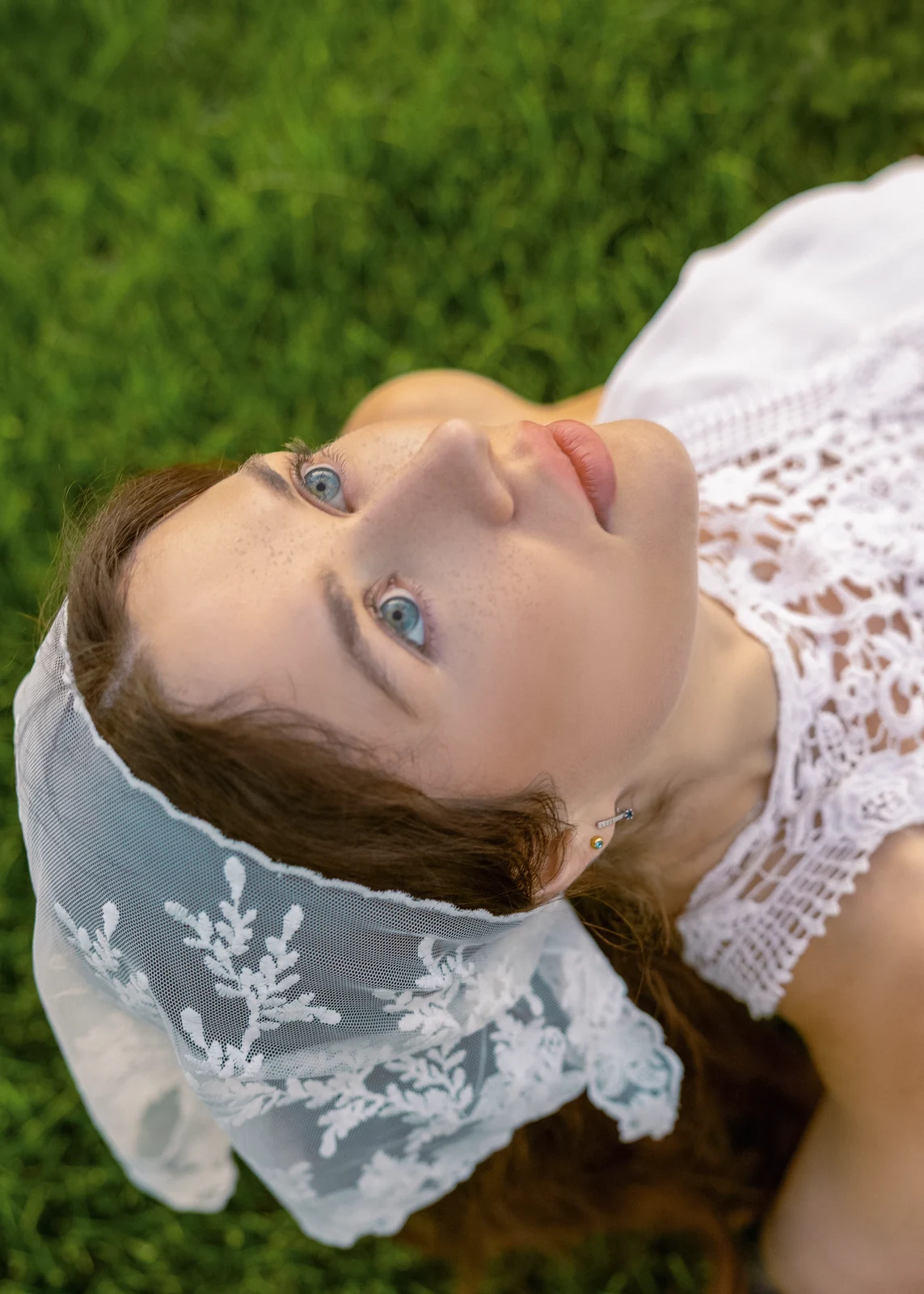 Outdoor portrait from a natural-light session — grass, trees, and golden-hour light.