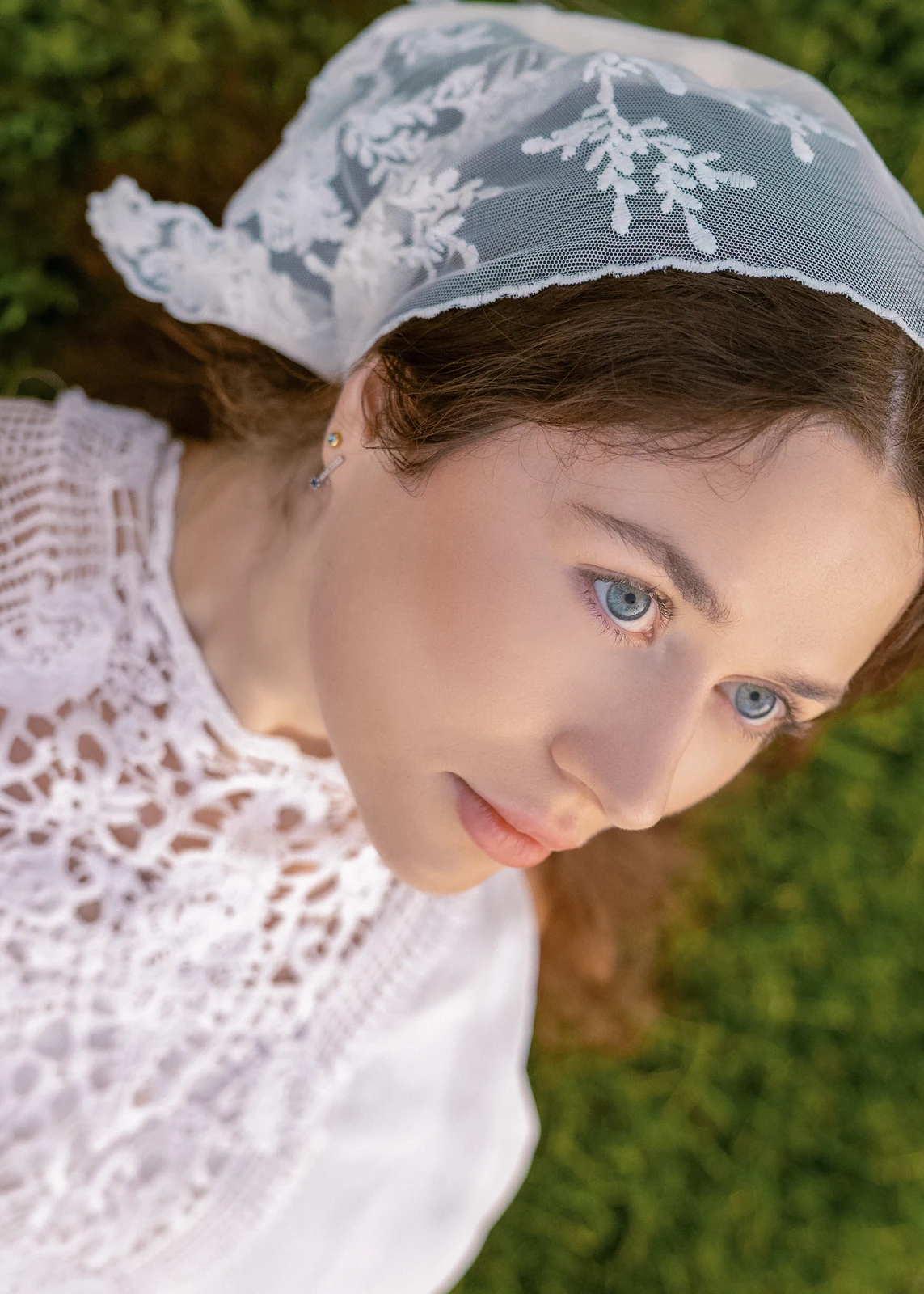 Outdoor portrait from a natural-light session — grass, trees, and golden-hour light.