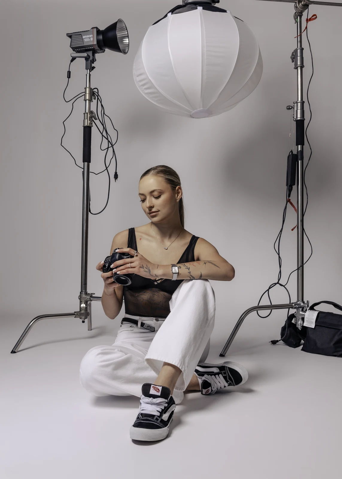 Studio portrait against a seamless backdrop — controlled lighting, editorial styling.