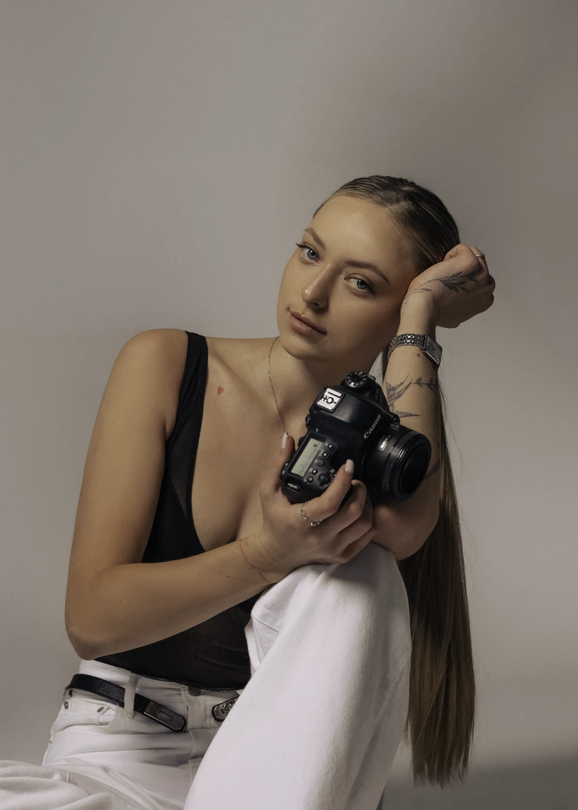 Studio portrait against a seamless backdrop — controlled lighting, editorial styling.