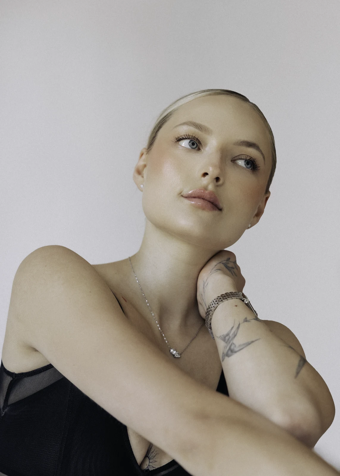 Studio portrait against a seamless backdrop — controlled lighting, editorial styling.