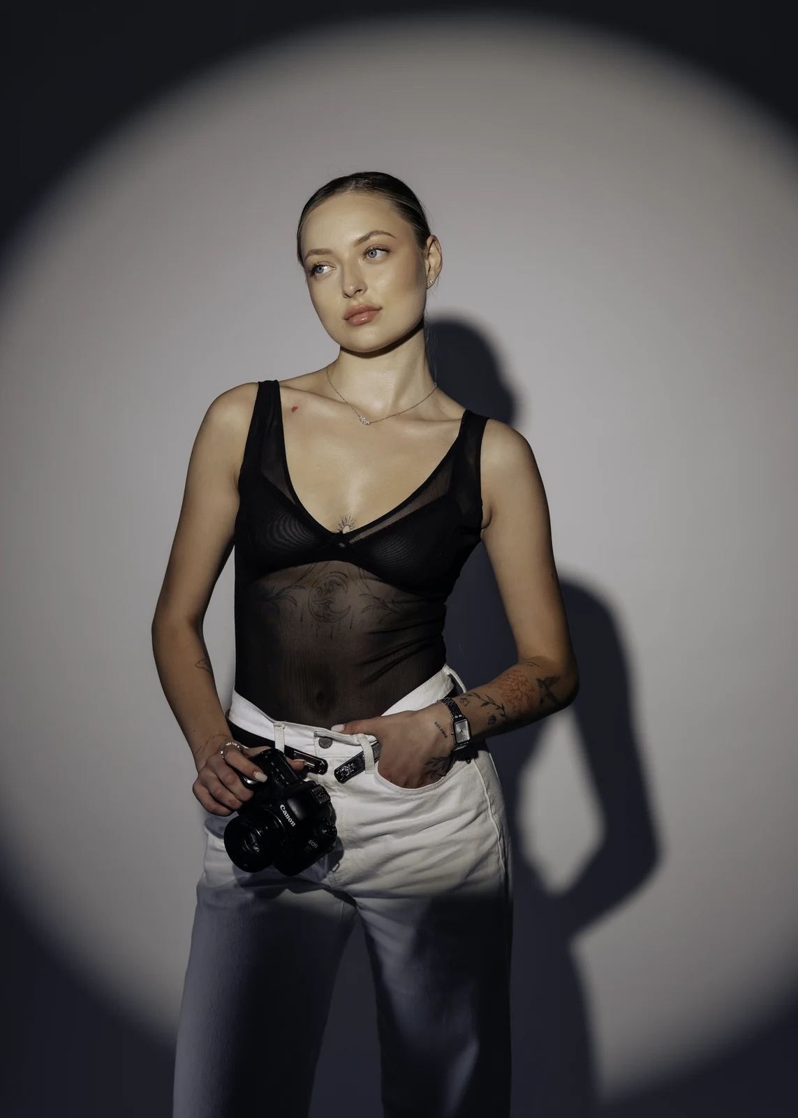 Studio portrait against a seamless backdrop — controlled lighting, editorial styling.