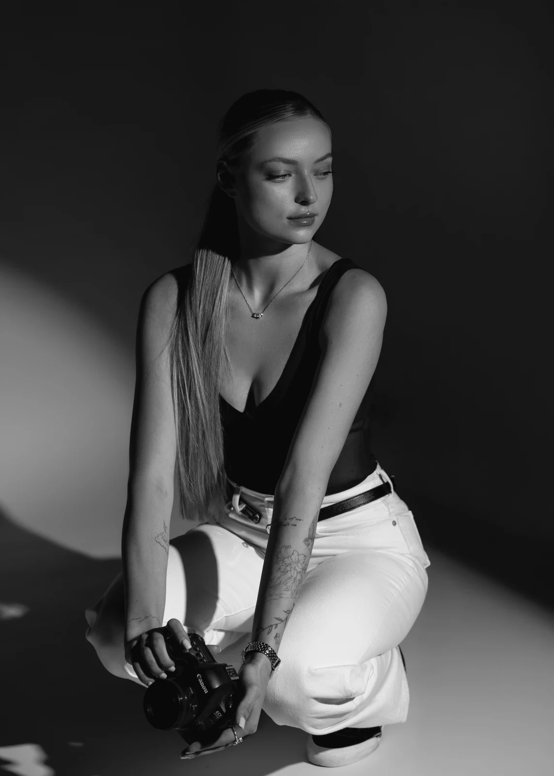 Studio portrait against a seamless backdrop — controlled lighting, editorial styling.