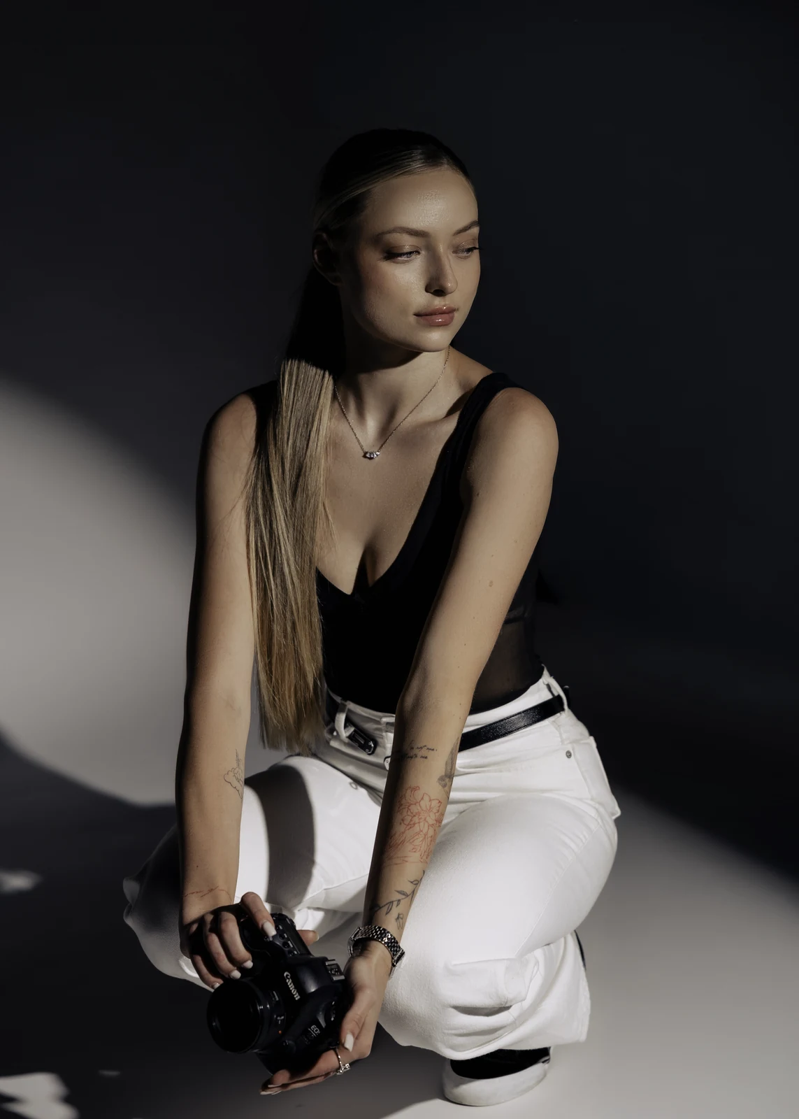 Studio portrait against a seamless backdrop — controlled lighting, editorial styling.