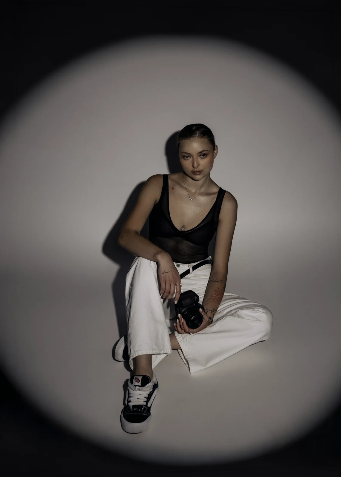 Studio portrait against a seamless backdrop — controlled lighting, editorial styling.