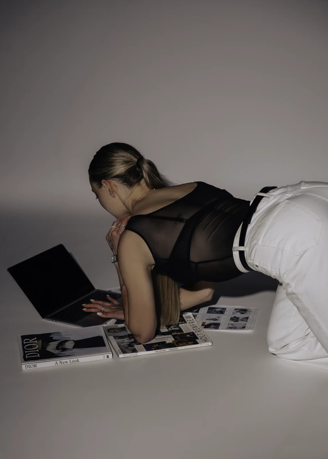 Studio portrait against a seamless backdrop — controlled lighting, editorial styling.