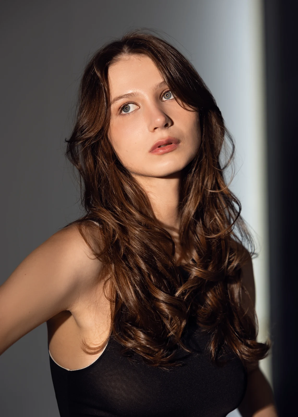 Studio portrait against a seamless backdrop — controlled lighting, editorial styling.