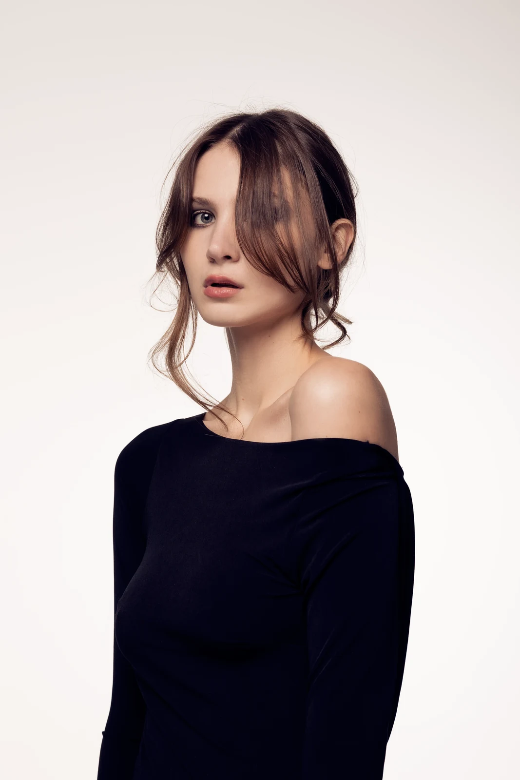 Studio portrait against a seamless backdrop — controlled lighting, editorial styling.