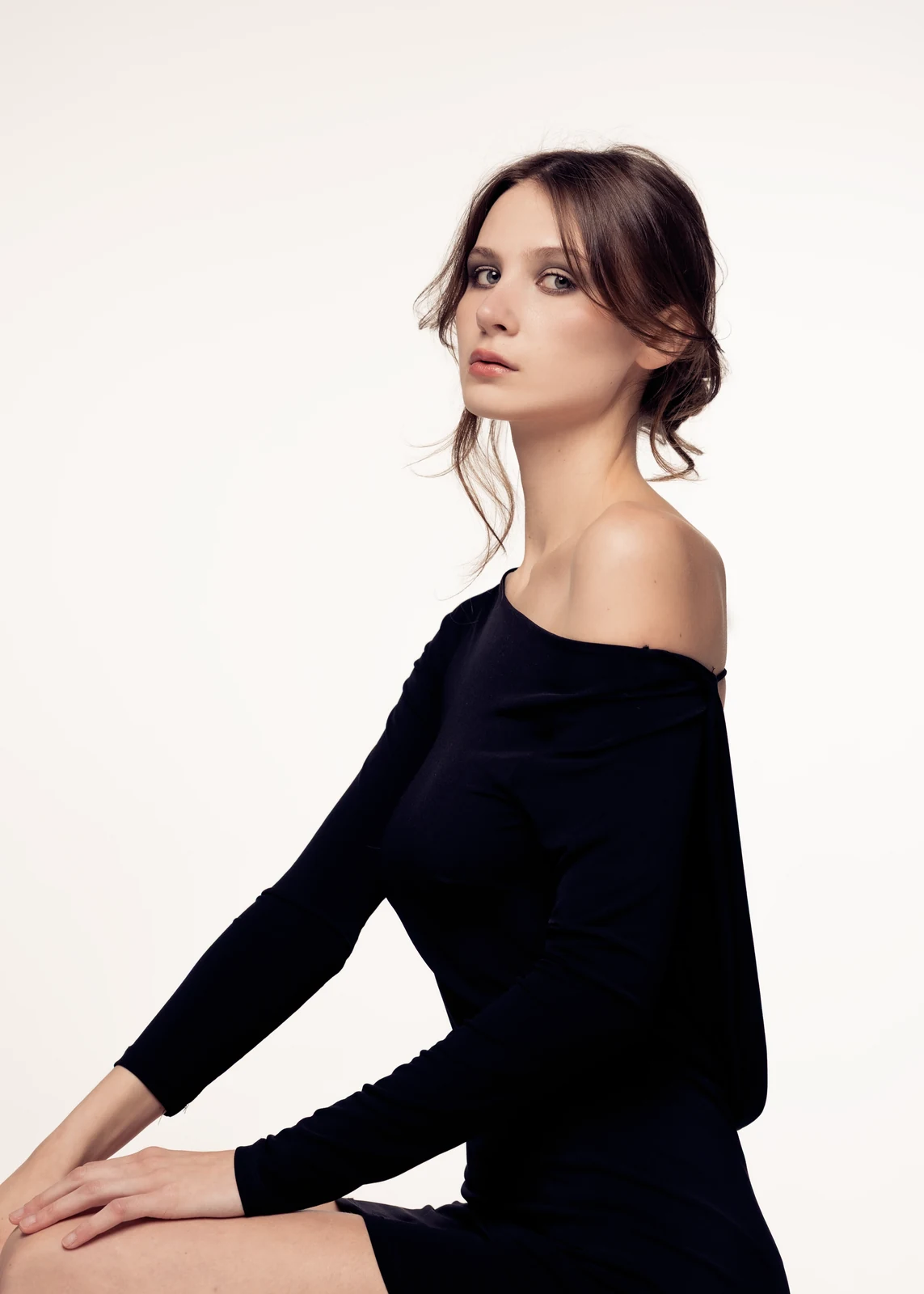 Studio portrait against a seamless backdrop — controlled lighting, editorial styling.