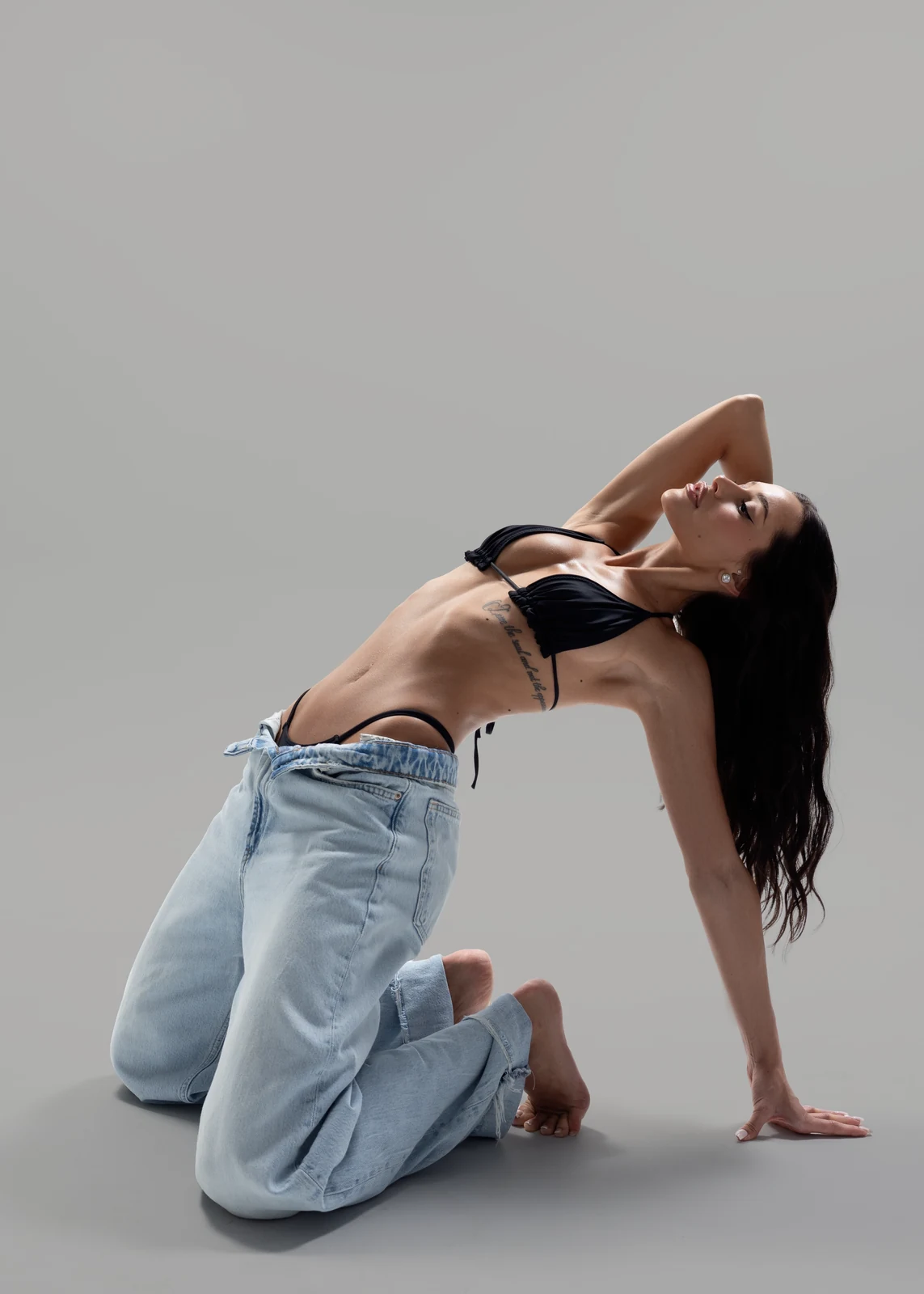 Studio portrait against a seamless backdrop — controlled lighting, editorial styling.